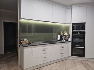 Grey-green glass splashback in a kitchen