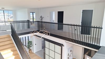 Postless architectural aluminium balustrade spanning an upper landing, Whitianga