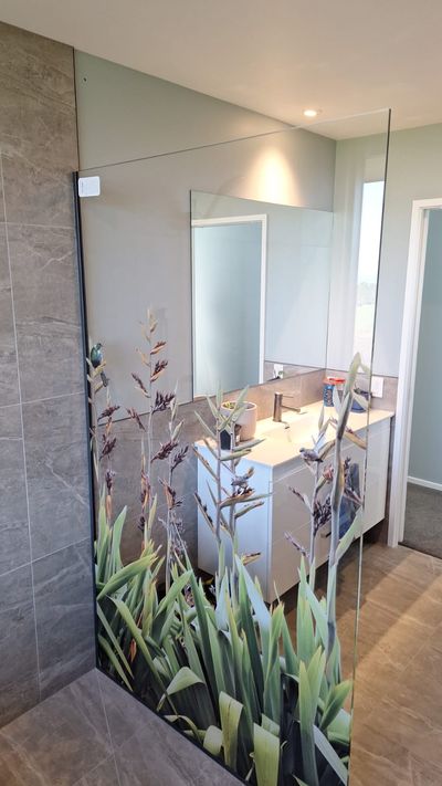 Printed frameless shower screen with a flax design, second angle
